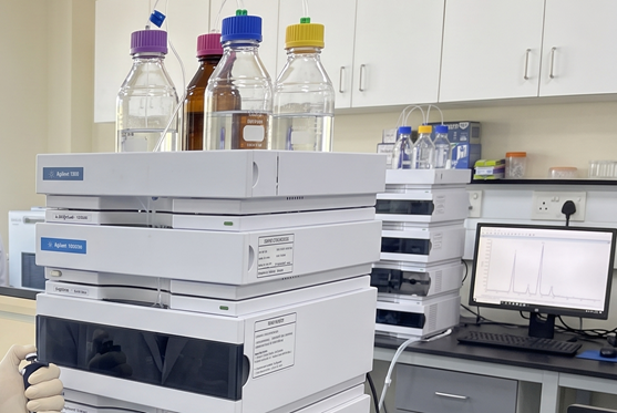 HPLC instrument stack with solvent bottles and data display